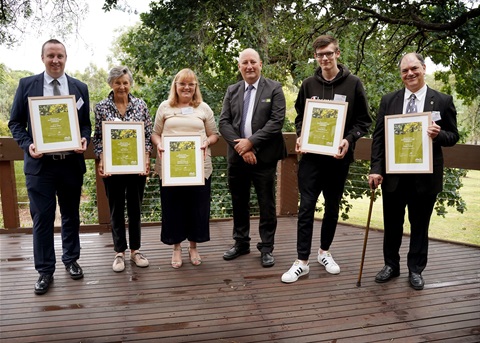 The Mayor, Peter Perkins, stands in a semi-circle with the 2021 Australia Day Award recipients.