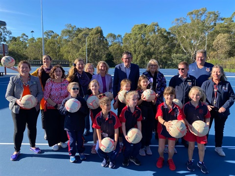 This is a photograph of Premier Daniel Andrews with local MPs, Councillors and members of the Diamond Creek Force Netball Association at the Diamond Creek netball courts.