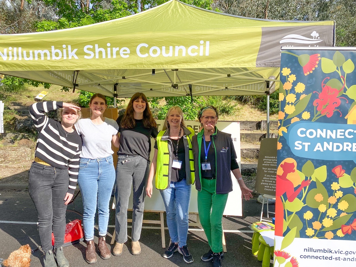 Photo of Council Officers and Community Members standing at the Connected St Andrews Stall smiling.