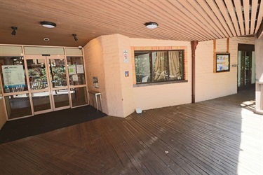 Timber ceiling over an entrance way with glass doors