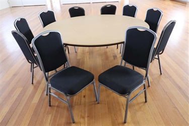 Dark fabric covered chairs around a round table