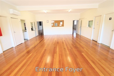 A large light room with shiny timber floors