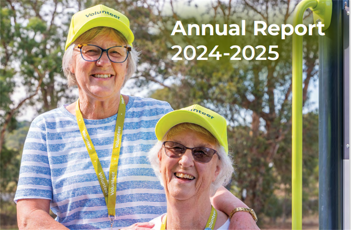 Two smiling women in a park