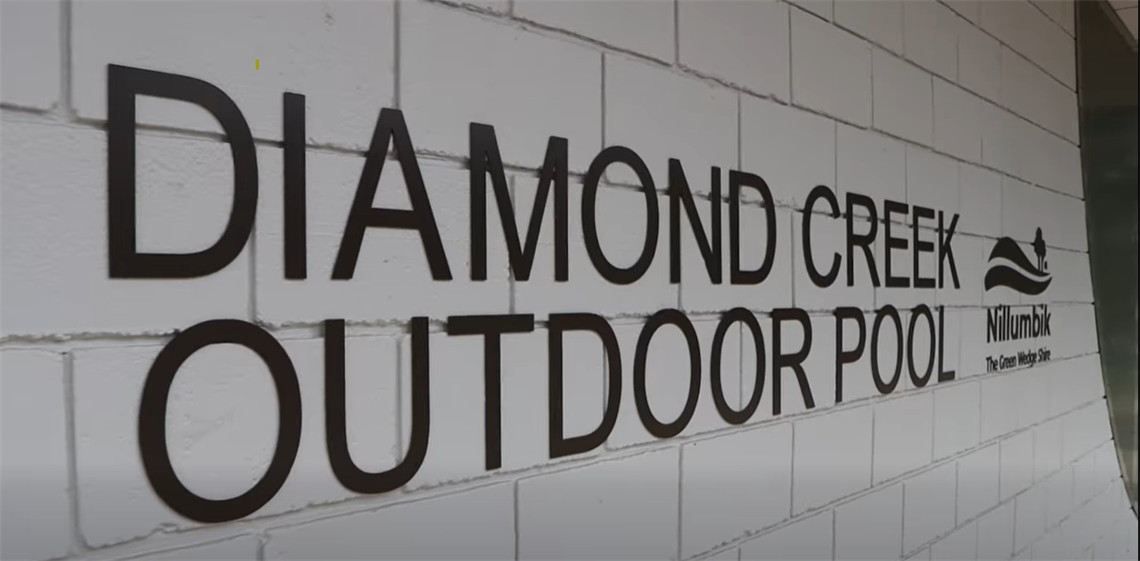 A close-up photo of the Diamond Creek Outdoor Pool exterior sign