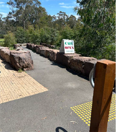 A smooth asphalt path between large rocks