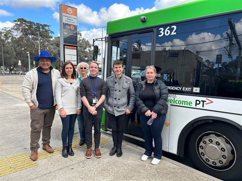 This is a photography of the Nillumbik Mayor Ben Ramcharan, Cr Richard Stockman and other community members at the Diamond Creek bus stop.