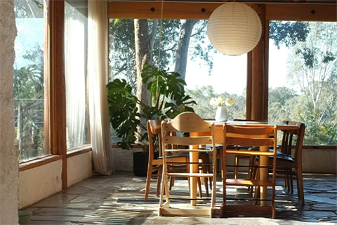 A dining room is flooded by sunlight